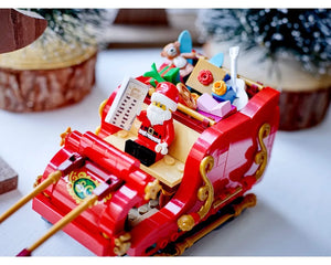 LEGO Santa's Sleigh (40499) with Santa minifigure, a nice list, and gifts, set against a blurry festive background.
