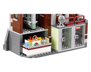 Ground floor section of LEGO Arkham Asylum 70912, showing a food stand with snacks and two clear security doors with keypads.