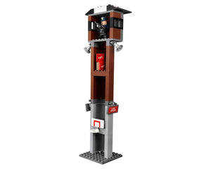 LEGO Arkham Asylum guard tower featuring a minifigure, TNT boxes, loudspeaker, basketball hoop, and a 'LOCK DOWN' sign.