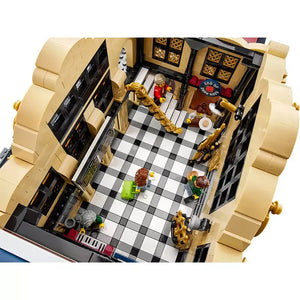 Overhead view of LEGO BrickLink 910034 Brick Cross interior with minifigures, golden staircase, and checkered floor.