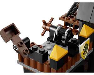 Close-up of LEGO Castle 7947 Prison Tower Rescue showing a brown winch, a printed shield, and brown/black/gold bricks.
