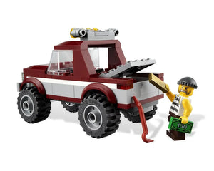 LEGO City 4437 Police Pursuit set showing a red and white pickup truck and a robber minifigure with gold bar and cash.