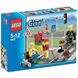 LEGO City set 8401 showing minifigures at a street crossing with a police officer, traffic light, and street signs.