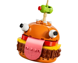 LEGO Fortnite Durrr Burger build, an orange burger character with large eyes, pink tongue, and green olive on top.