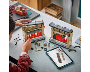 Hands building LEGO Harry Potter 76450 Book Nook: Hogwarts Express set, showing train sections, minifigures, and a tablet.