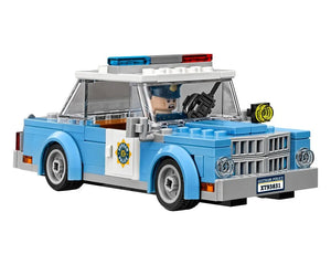 Light blue LEGO Gotham Police car with a minifigure driver, emergency lights, and a GOTHAM POLICE shield on the side.