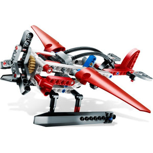 Detailed LEGO Technic 8046 Helicopter, red and white, showcasing complex gears and a rotating propeller on a stand.