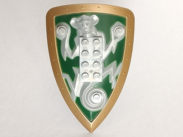 LEGO large figure shield with a gold border, green background, and a silver monkey relief holding spheres, featuring an integrated 2x4 LEGO brick.