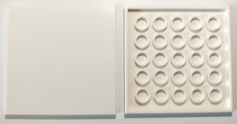 Two white LEGO 6x6 tiles, one showing the smooth top and the other showing the bottom with 25 circular tubes.