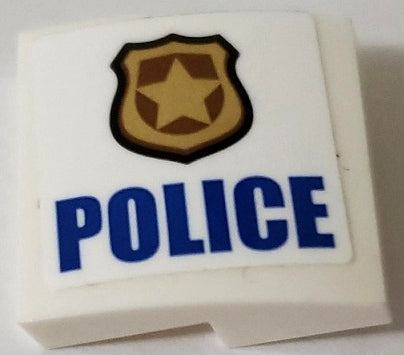 White LEGO curved slope with gold police badge and blue 'POLICE' sticker, model left side.