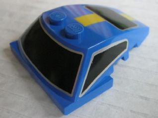 Blue LEGO Wedge 5 x 4 x 1 1/3 with 2x4 base, featuring black windows and a yellow stripe pattern on top.