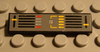 A close-up of a LEGO 1x4 dark gray tile with a yellow and red control panel pattern, featuring sliders, bars, and a fan symbol.