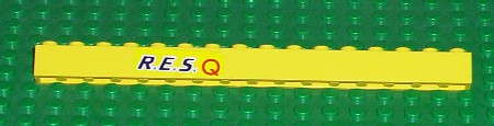 Yellow LEGO 1x16 brick part 2465pb03, with black 'R.E.S.' and red 'Q' print, on a green baseplate.