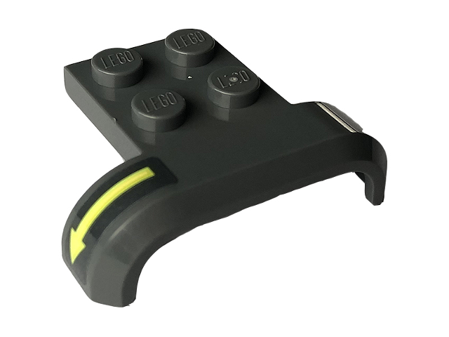 Dark gray LEGO vehicle mudguard 4x3x1 piece with four studs and a yellow arrow pattern on the curved right side.