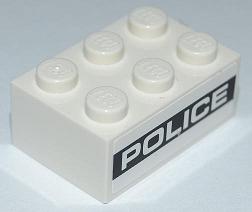 White LEGO 2x3 brick with six studs, featuring 'POLICE' text on a black background stripe on its side.