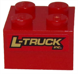 Close-up of a red LEGO 2x2 brick with four studs, featuring a gold 'L-TRUCK inc.' pattern on its side from Set 8147.
