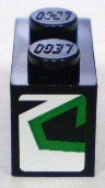 Black LEGO 1x2 brick with two studs, featuring a white sticker on one end with a green stylized 'Z' design.