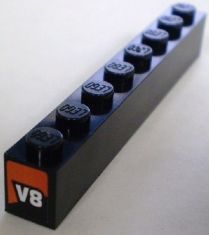 Black LEGO 3008pb115 1x8 brick with eight studs, featuring an orange V8 logo on one end, from set 8898.