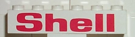 White LEGO 1x6 brick (3009pb004) with red 'Shell' bold pattern.