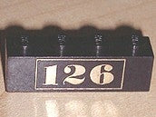 Black LEGO 1x4 brick with gold '126' number pattern on the side.
