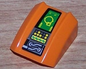 Orange LEGO curved 2x2 slope brick with a sticker depicting a control panel, green target screen, wires, and buttons.