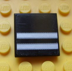 Black LEGO 2x2 tile with two horizontal silver stripes pattern (sticker) on a yellow baseplate background.