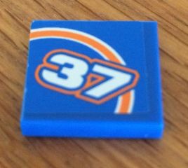 Blue LEGO 2x2 tile, part 3068pb0908R, with white '37' outlined in orange and an orange bow pattern.