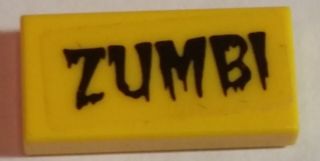 Yellow LEGO 1x2 tile with a black dripping 'ZUMBI' pattern, part 3069pb0437 from set 5973.