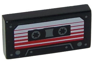 LEGO 1x2 black tile featuring an audio cassette print with a white label, red stripes, and tape reels.