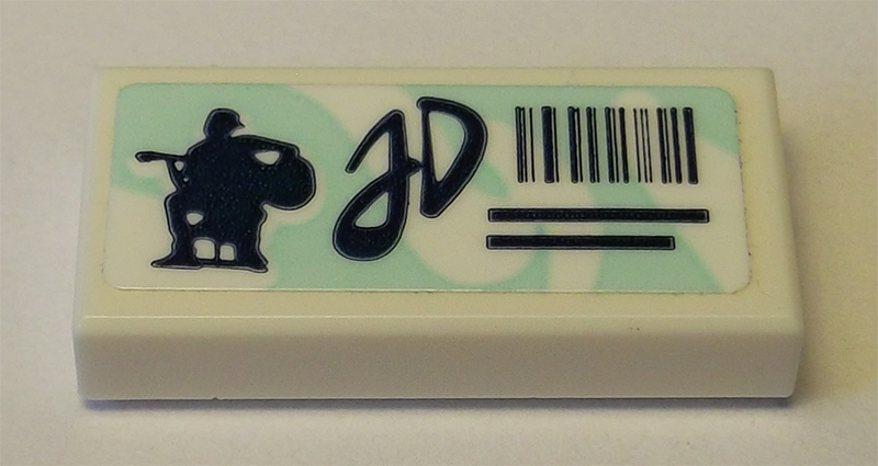 LEGO Tile 1x2 with light aqua swirl background, black guitar player silhouette, 'JD' script, and barcode pattern sticker.