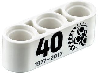 White LEGO Technic 1x3 thick liftarm with black '40', '1977-2017' text, and a 24-tooth gear pattern.
