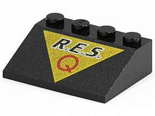 Black LEGO Slope 33 3 x 4 brick with 'R.E.S.' and red 'Q' on a yellow triangle pattern.
