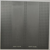 Dark gray LEGO 32x32 road baseplate with 7-stud straight sides, double driveway, and two 'KEEP CLEAR' patterns.