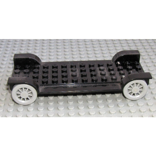 Black LEGO Fabuland Car Chassis 6x14 without hitch, featuring two light gray wheels, resting on a gray baseplate.