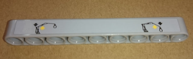 Light grey LEGO Technic 1x9 liftarm with a sticker showing two crane operating instructions patterns, each with a downward arrow and yellow light.