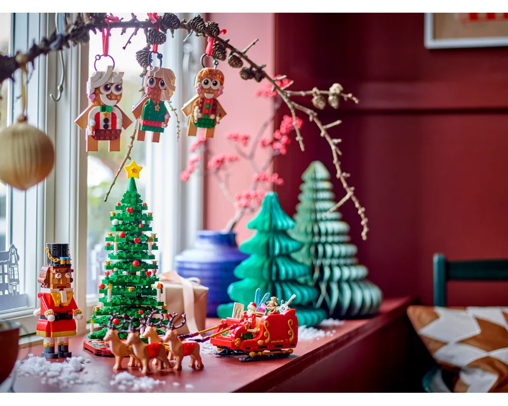 LEGO Nutcracker 40640, a LEGO Christmas tree, Santa's sleigh with reindeer, and gingerbread ornaments in a festive setting.