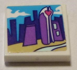 White LEGO 2x2 tile with sticker showing a city skyline: purple and blue buildings, yellow ground, light blue water, and a heart-topped skyscraper.
