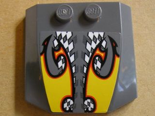 Grey LEGO 4x4 triple curved wedge plate with two studs, featuring a sticker of yellow flames over a checkered pattern.