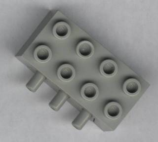 Light gray LEGO 4692 Pneumatic Distribution Block 2x4 with 8 studs on top and 3 pneumatic connectors on the side.