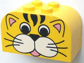 Yellow LEGO curved slope brick with four studs and a cute cartoon tiger face print, featuring black stripes, pink ears, and a tongue.