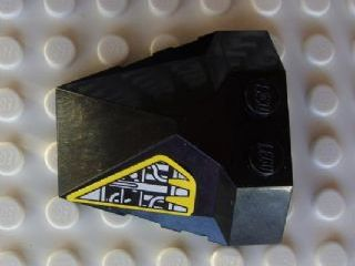Black LEGO Wedge 4x4x1 1/3 Pyramid Center with yellow and silver machinery pattern sticker on the left side.