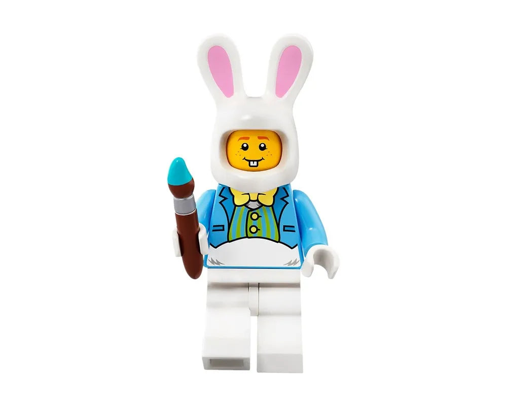 LEGO minifigure in a white bunny costume with pink ears, blue jacket, yellow bow tie, and holding a blue-tipped paintbrush.