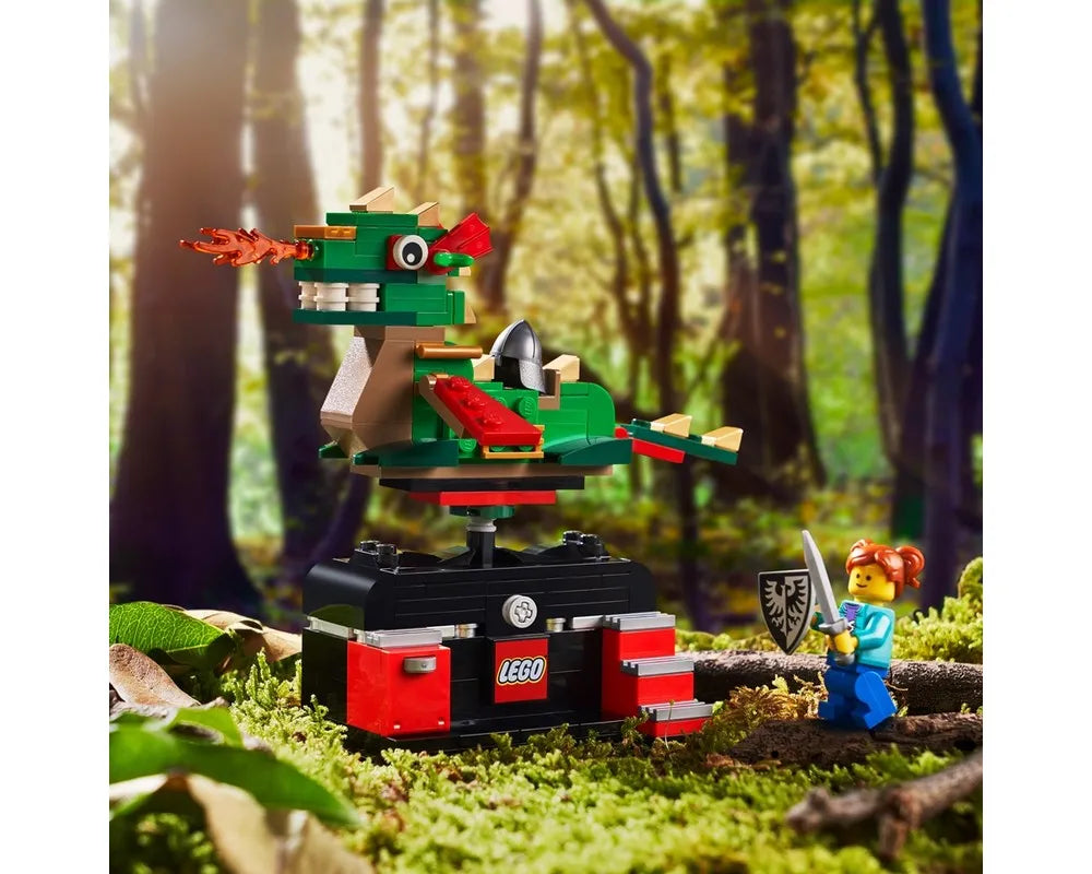 LEGO 5007428 Dragon Adventure Ride set with a green dragon breathing fire, next to a minifigure knight in a forest.