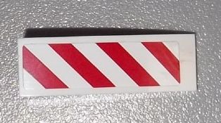 White LEGO sticker for Slope, Curved 3 x 1, featuring red and white diagonal danger stripes angled to the right.