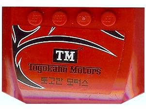 Red LEGO 4x6x2/3 curved wedge part with 'Togokahn Motors' sticker featuring TM logo and black/white design.