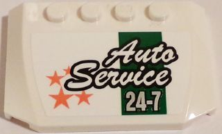 White LEGO 4x6 curved wedge with 'Auto Service 24-7' text, green stripe, and orange stars sticker pattern.