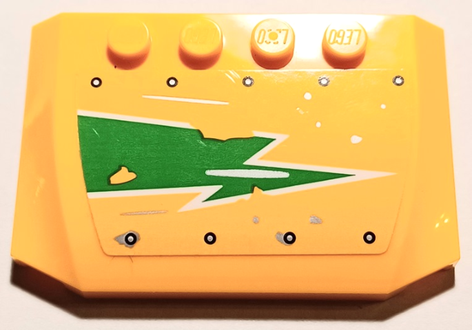 Yellow LEGO 4x6x2/3 triple curved wedge with worn green and white lightning bolt and silver rivets pattern.
