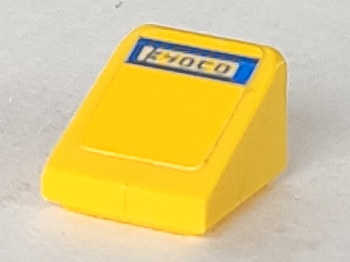 Close-up of LEGO 54200pb005, a yellow Slope 30 1x1x2/3 brick with a blue 'Kyoto' pattern sticker.