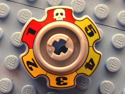 Close-up of LEGO 57520pb01 Technic Tread Sprocket Wheel with skull and numbers 1-5, on a light blue LEGO baseplate.