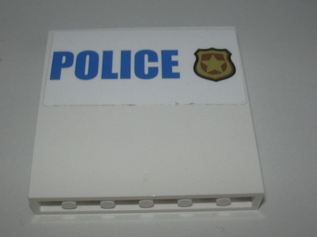 White LEGO panel 1x6x5 with blue 'POLICE' text and gold police badge sticker on a white background.